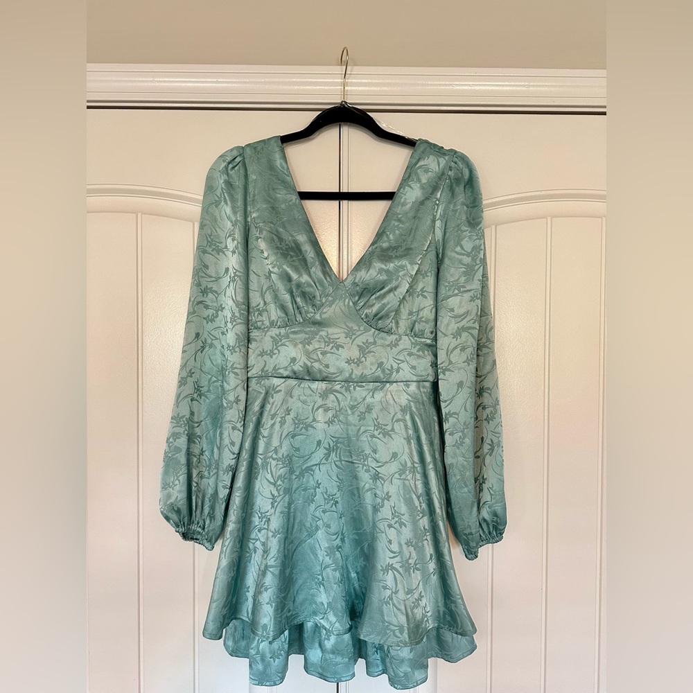 Blue satin dress with bell sleeves and open adjustable back.